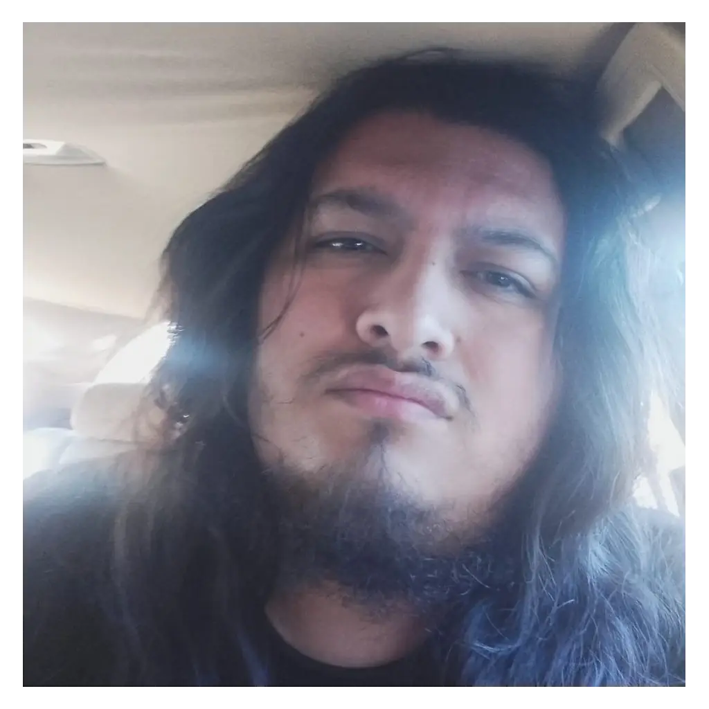 Ruben Ramirez a man with shoulder length dark hair, beard and mustache