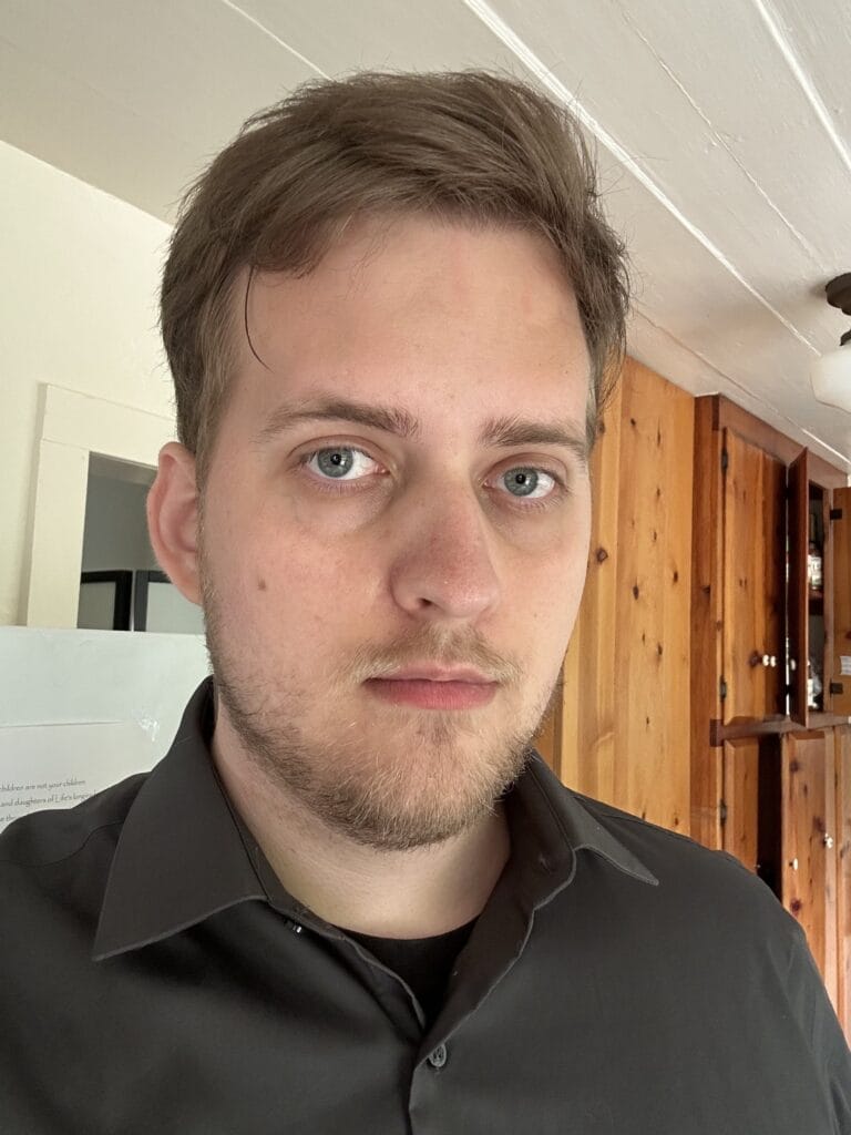 Paul O'Connell looking into the camera with a slight smile. He is wearing a dark gray collared shirt.